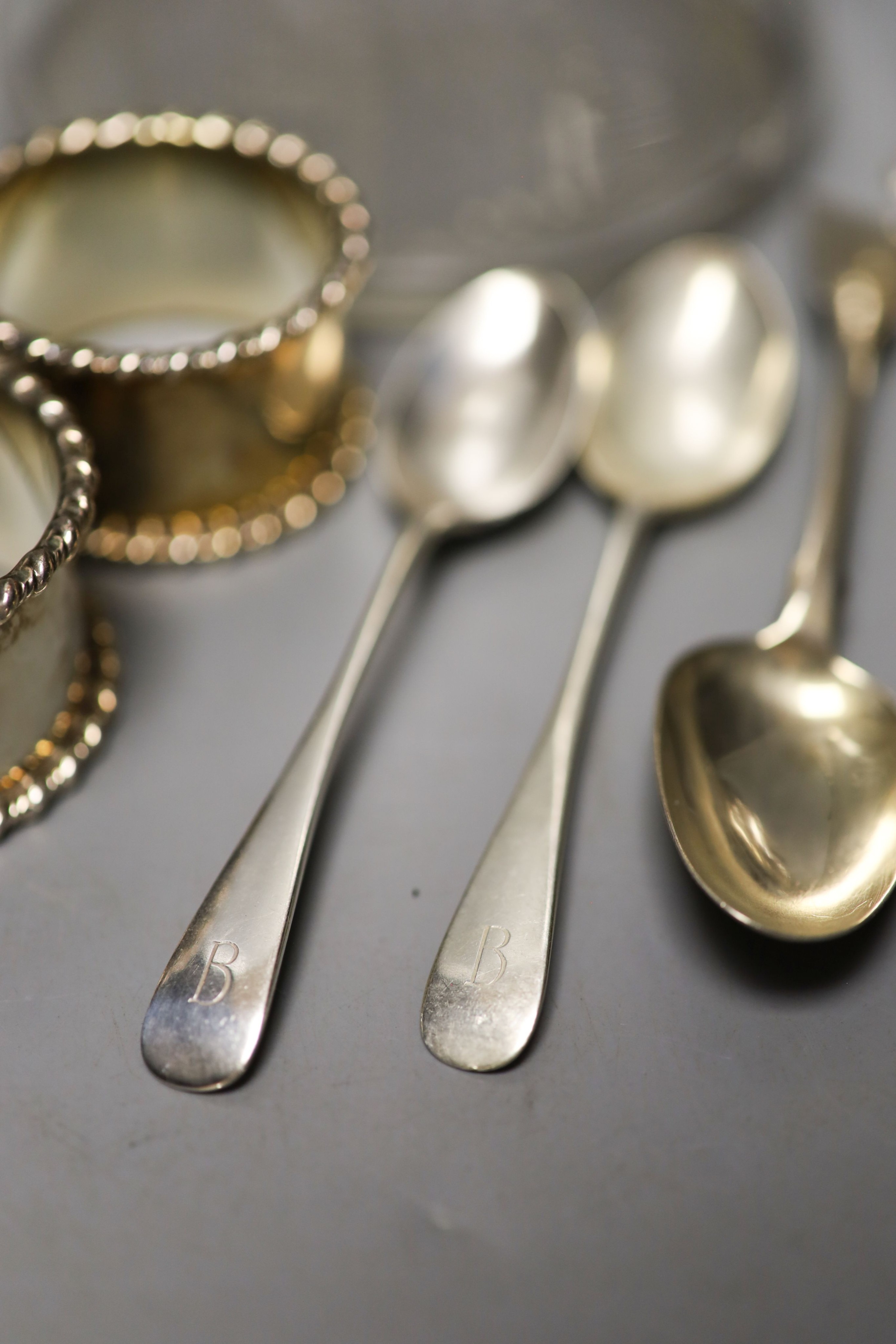 Five 19th century Irish silver fiddle pattern teaspoons, by Isaacs, two similar Scottish teaspoons, a pair if silver napkin rings, a Victorian silver bun salt and a silver plate mounted glass claret jug.